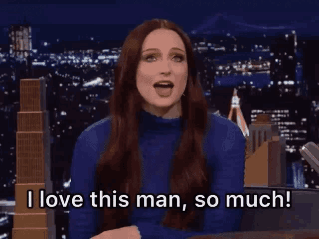 a woman in a blue sweater is saying i love this man so much .
