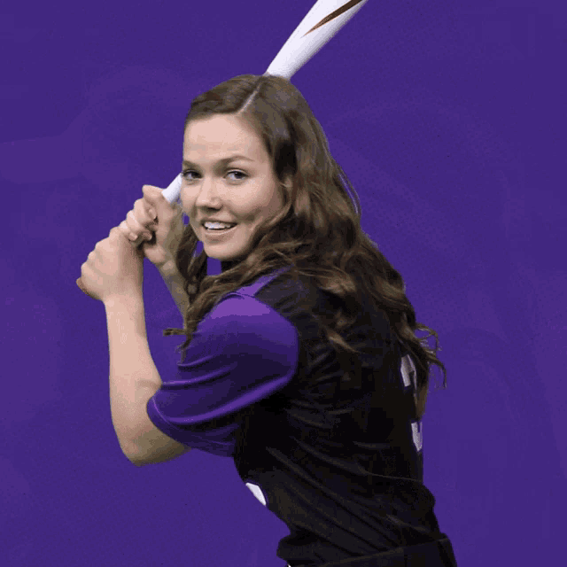 a girl wearing a black jersey with bridges 3 on it