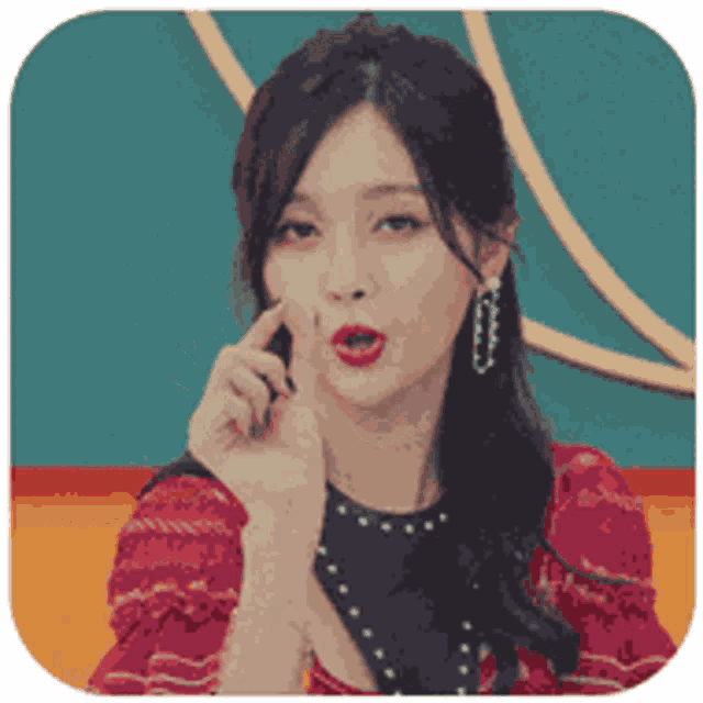 a woman in a red dress is making a funny face with her hand on her face .