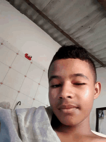 a young man with his eyes closed is laying on his back