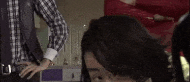 a man and a woman are standing next to each other in a room .