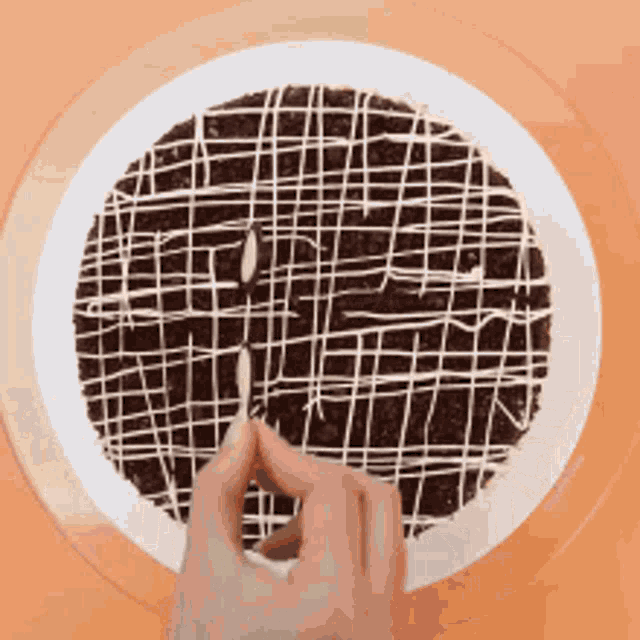 a person is cutting a piece of cake with a knife .