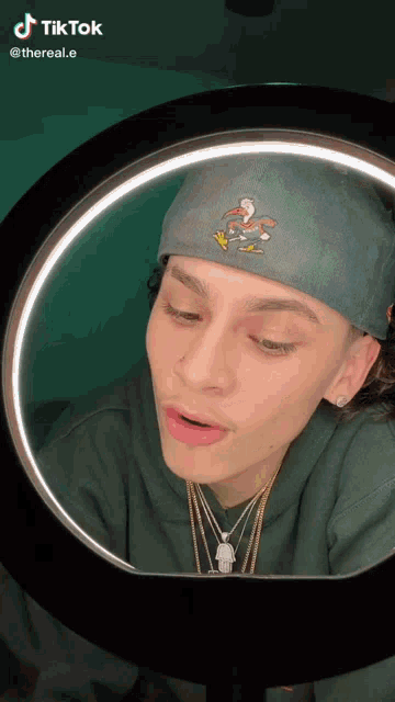 a young man wearing a headband is looking at himself in a mirror