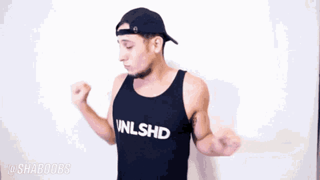 a man wearing a black tank top that says nlshd