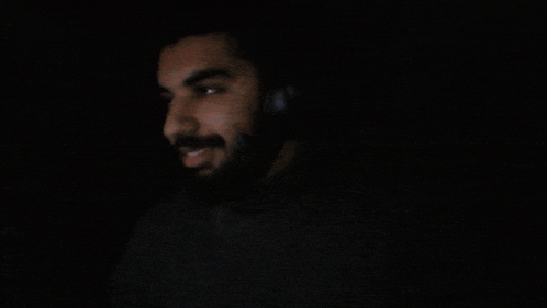 a blurry image of a person covering their face with their hands
