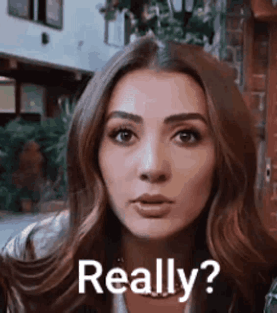 a woman is making a funny face and says `` really ? ''