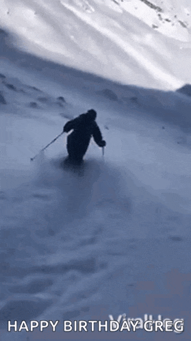 a person is skiing down a snow covered hill .
