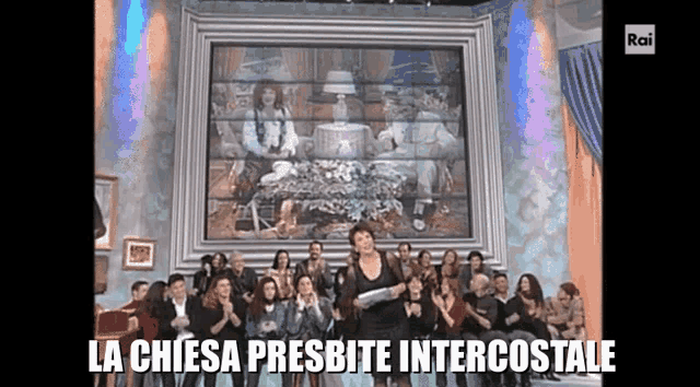 a woman stands in front of a large framed picture that says la chiesa presbite intercostale