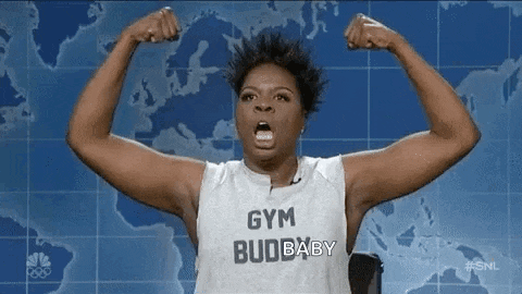 a woman is flexing her muscles in front of a map of the world .