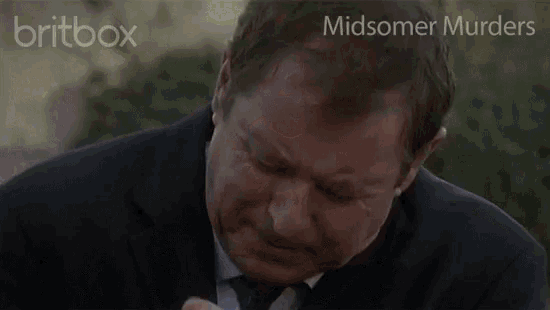 a man in a suit and tie is looking at the camera with the words midsomer murders behind him