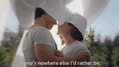 a man and woman are hugging with the words " there 's nowhere else i 'd rather be " visible