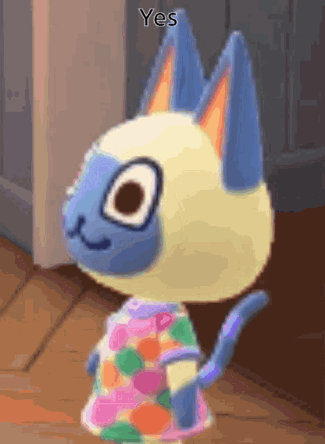 a cartoon cat wearing a colorful shirt with the word yes on it