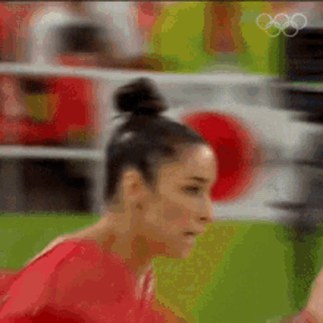 a close up of a woman 's face with the olympic rings visible