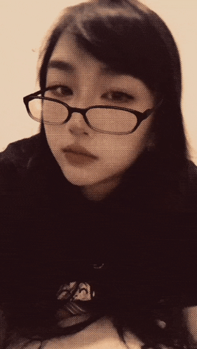 a woman wearing glasses has the word widi written on her face