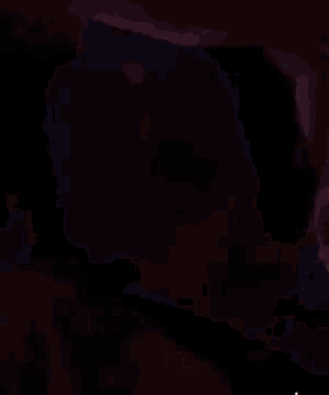 a blurry photo of two people kissing in a crowd