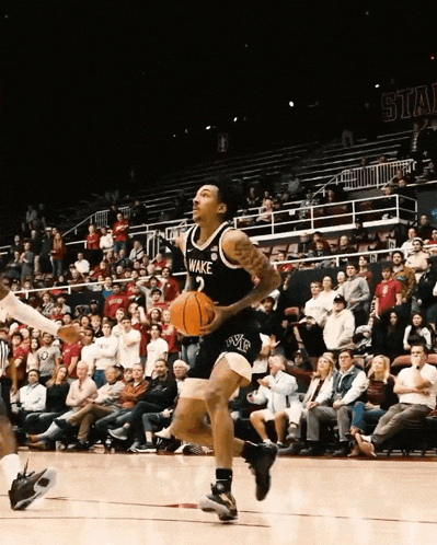 a wake basketball player dribbles the ball on a court