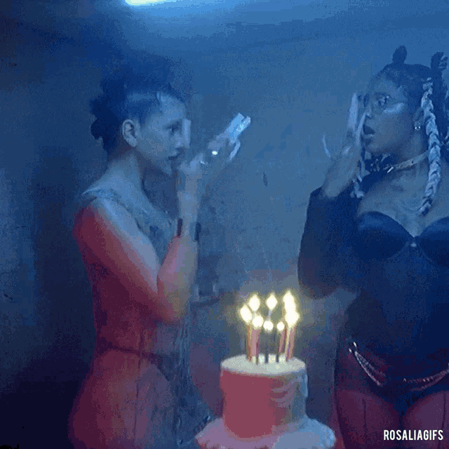 a woman blowing out candles on a cake with the word rosalia gifs below her