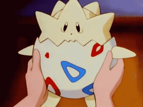 a person is holding a toy that looks like an egg with a star on it
