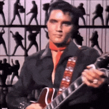 elvis presley is wearing a red scarf and playing a guitar .