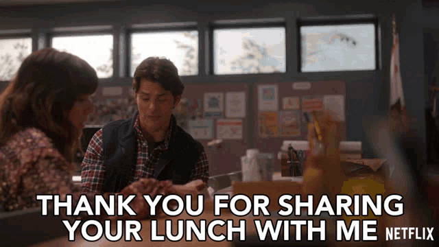 a man and a woman are sitting at a table with a caption that says thank you for sharing your lunch with me netflix