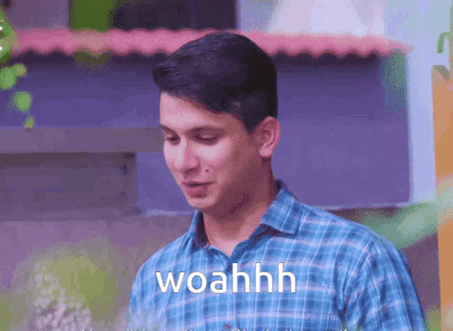 a man in a blue plaid shirt says woahh