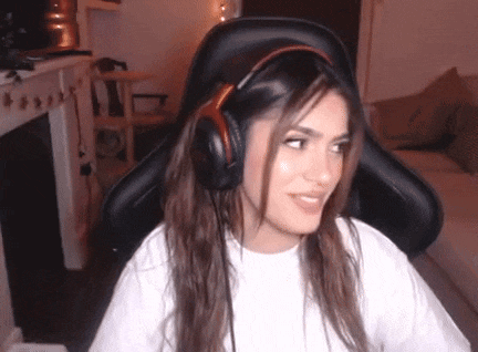 a woman wearing headphones is sitting in a chair in a living room .