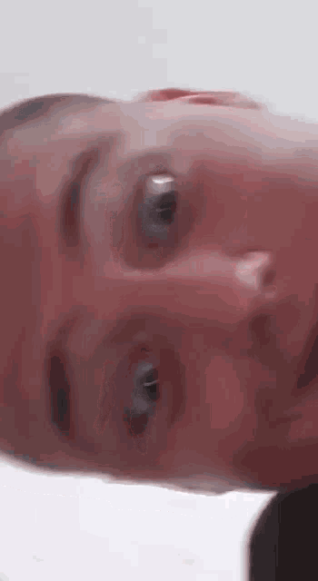 a close up of a person 's face with their eyes closed .