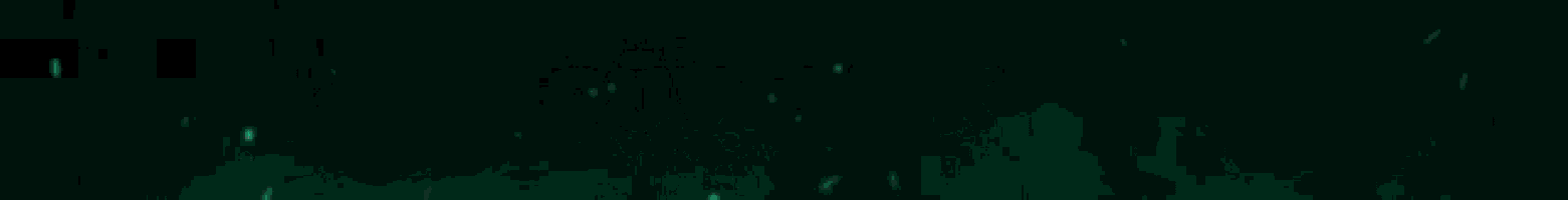 a green light is shining on a dark background