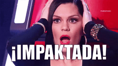 a woman with a surprised look on her face holds her hands to her head and says impactada
