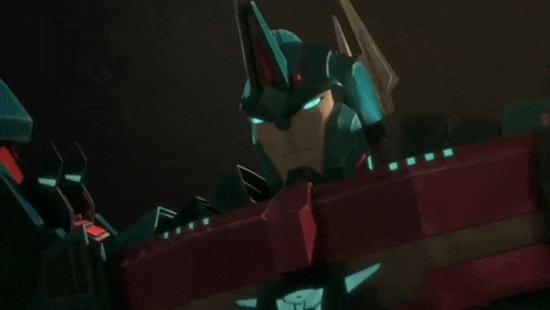 a close up of a transformer robot with blue eyes and a red sword .