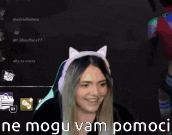 a woman wearing a cat ear headband is smiling while playing a video game on a computer .
