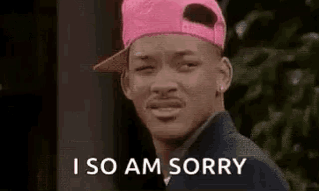 a man wearing a pink hat is saying `` i am sorry '' .