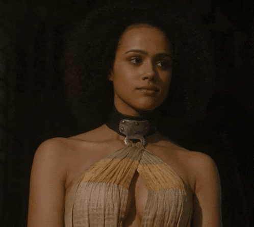 a woman with a choker around her neck looks down at something