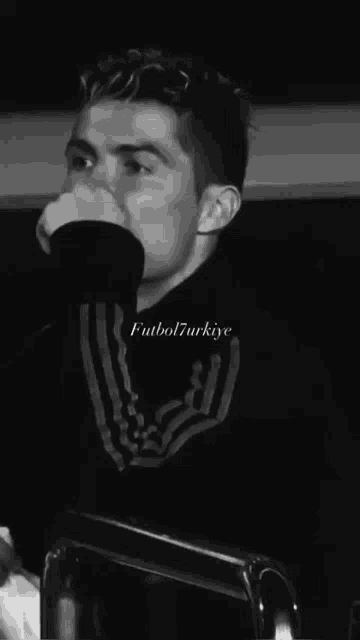 a black and white photo of a man with the words futbol7turkiye written on the bottom