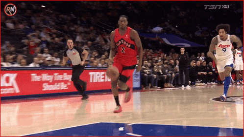 a basketball player with the number 2 on his jersey runs on the court