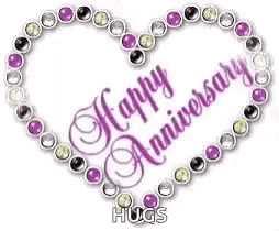 a purple heart with the words `` happy anniversary '' surrounded by rhinestones on a white background .