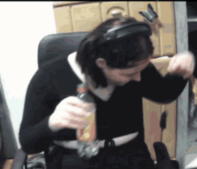 a woman wearing a headband holds a bottle in her hand