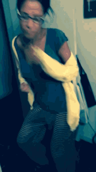 a blurry picture of a woman wearing a yellow sweater