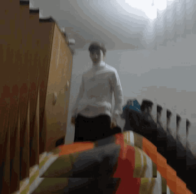 a blurry picture of a man standing in a bedroom