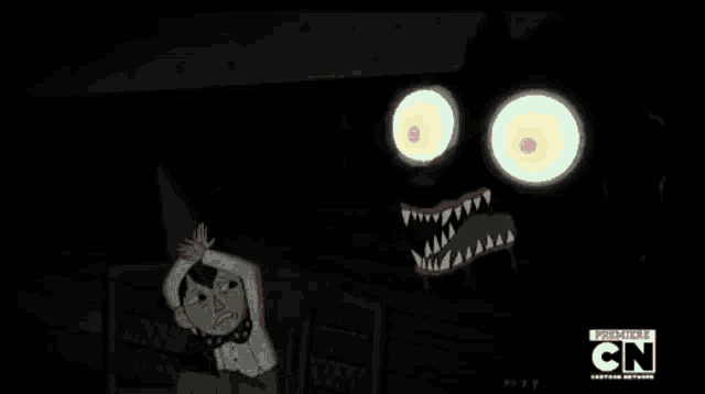 a close up of a cartoon character 's face with sharp teeth and glowing eyes .