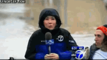a woman wearing a columbia jacket is talking into a microphone on abc 7 news