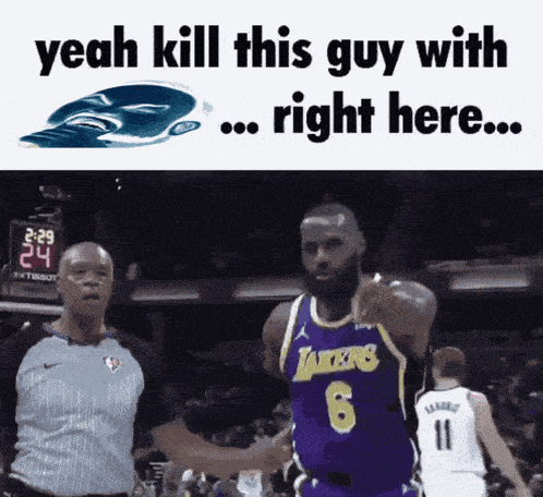 a basketball player wearing a lakers jersey is pointing at a referee