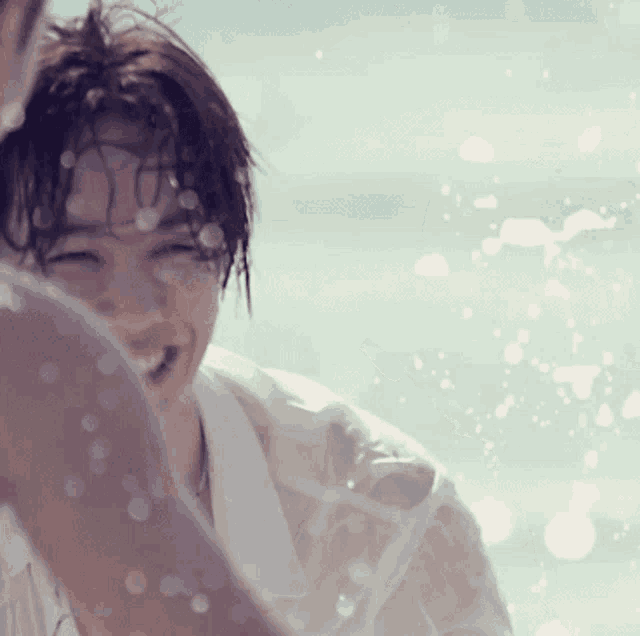 a man in a white shirt is being sprayed by water