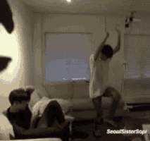 a man in a white shirt is dancing in a living room with the words seoul sister sophi on the bottom