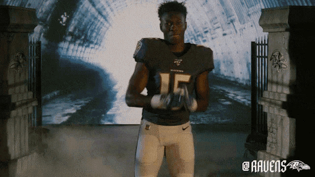 a man in a ravens jersey is standing in front of a tunnel