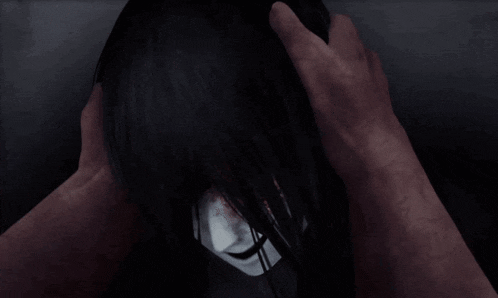 a person is touching a woman 's head with their hand