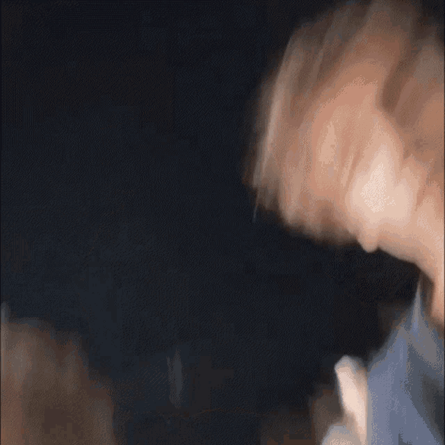 a blurry picture of a man 's face with a hand on it