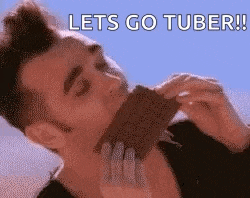 a man is eating a chocolate bar with the words `` lets go tuber ! ''