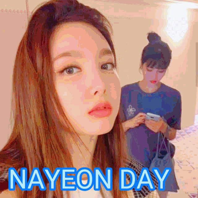 a woman taking a selfie next to another woman with the words nayeon day written on the bottom