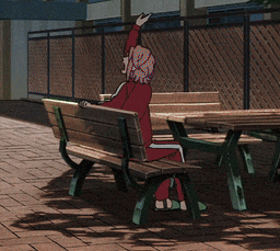 a girl is laying on a bench with her head on the back